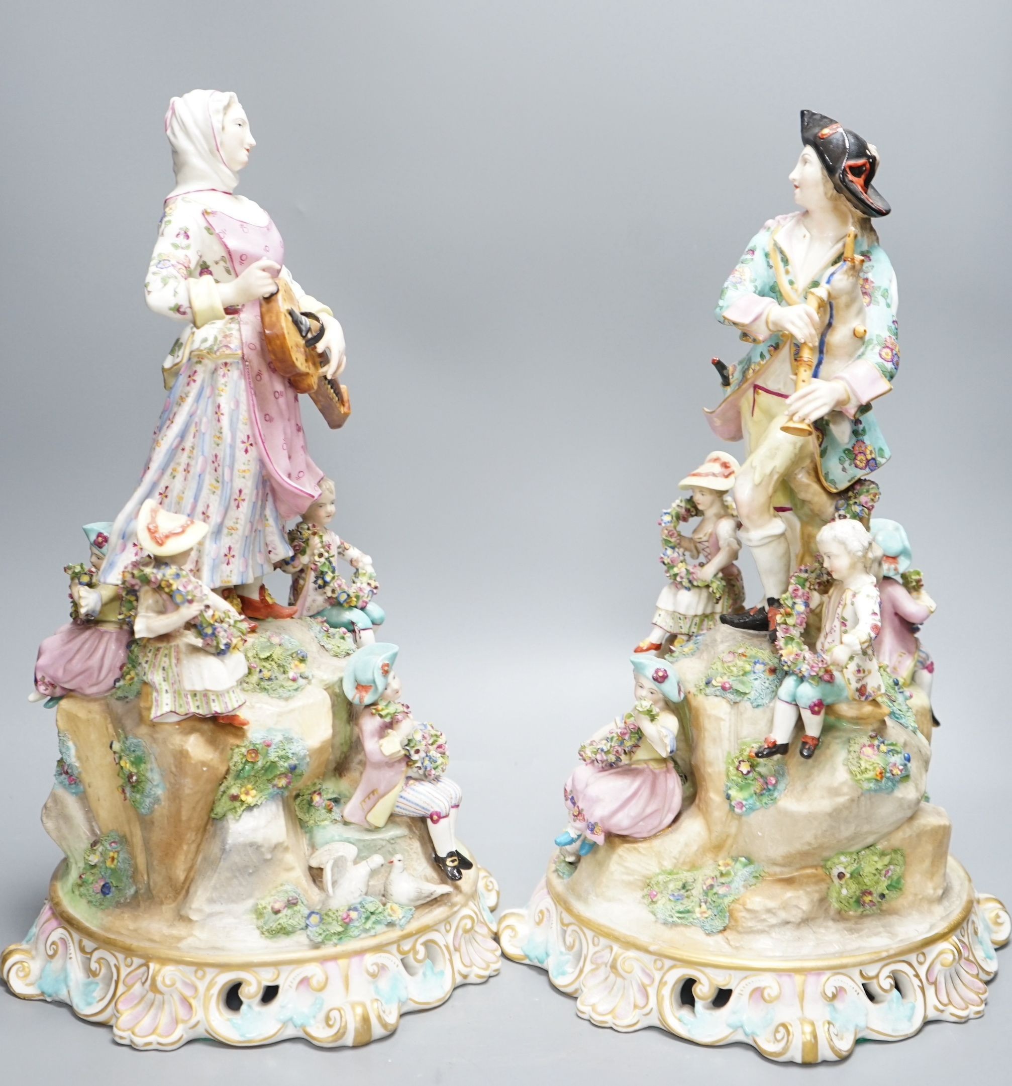 A pair of Meissen style porcelain musician figure groups, 42cms high